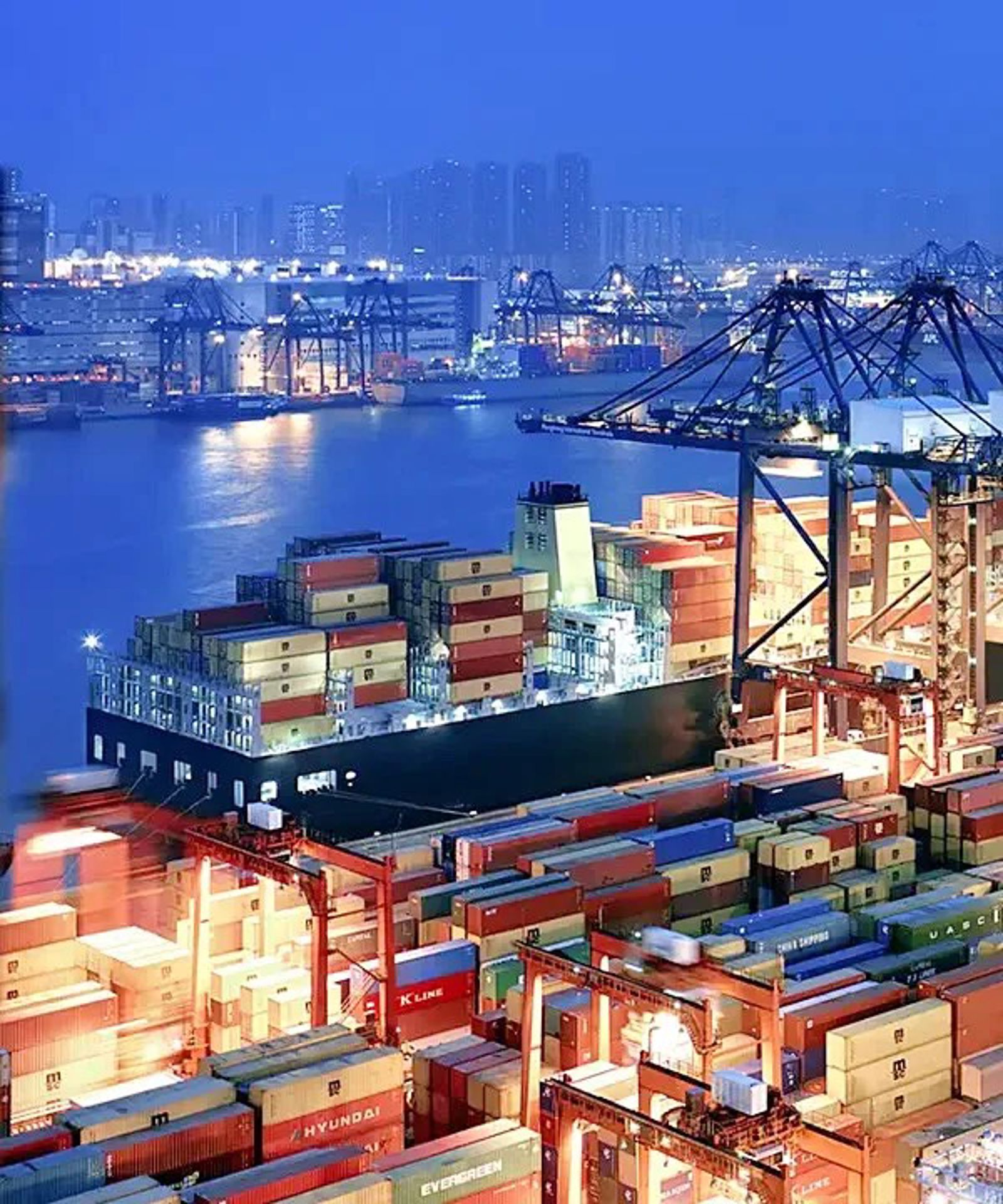 A large warehouse with a bridge in the background.