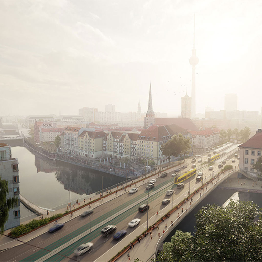 A river with a bridge and buildings.