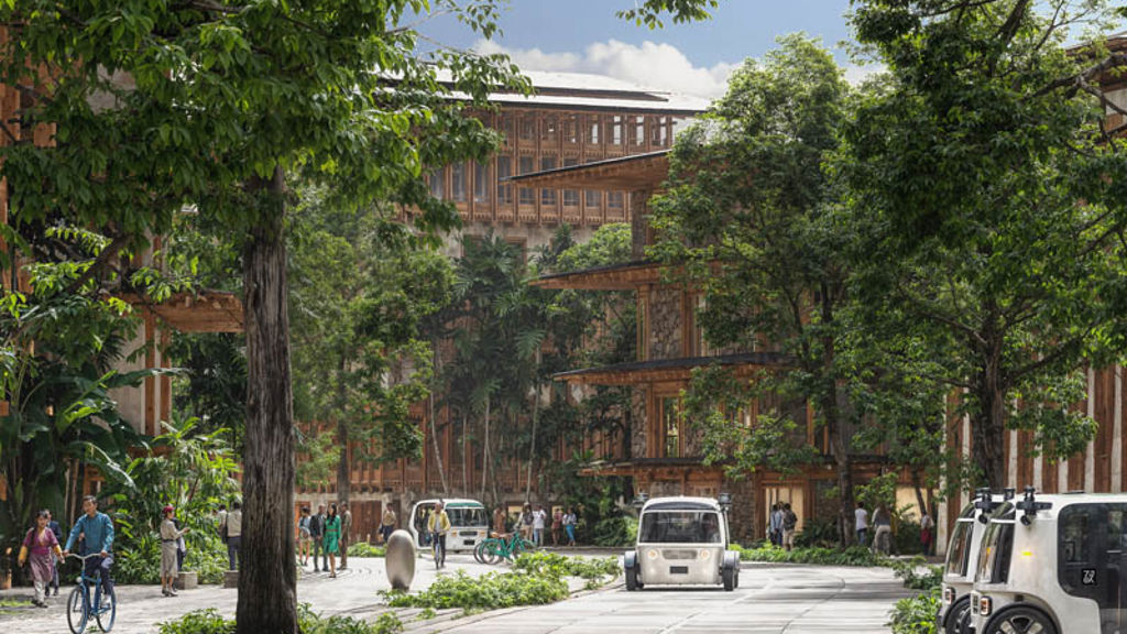 A street with cars and people on it and trees on the side.