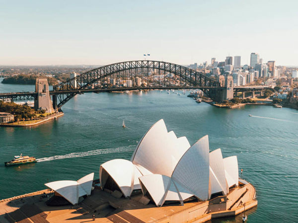 A boat on the water with Sydney Harbour Bridge in the background.