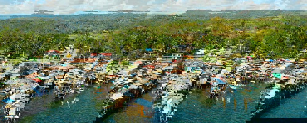 Wooden houses built on the river in a low socio-economic neighbourhood in an Asian city