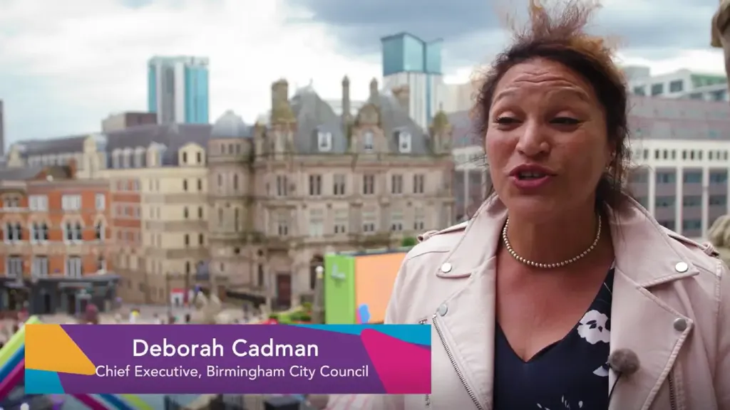 Deborah Cadman talking in front of cityscape of Birmingham