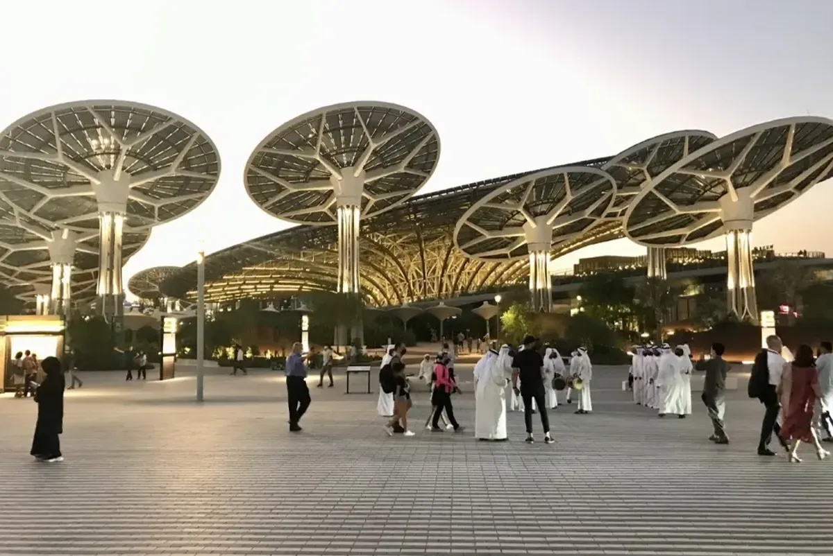 People walking at Expo Dubai 2020 at sunset