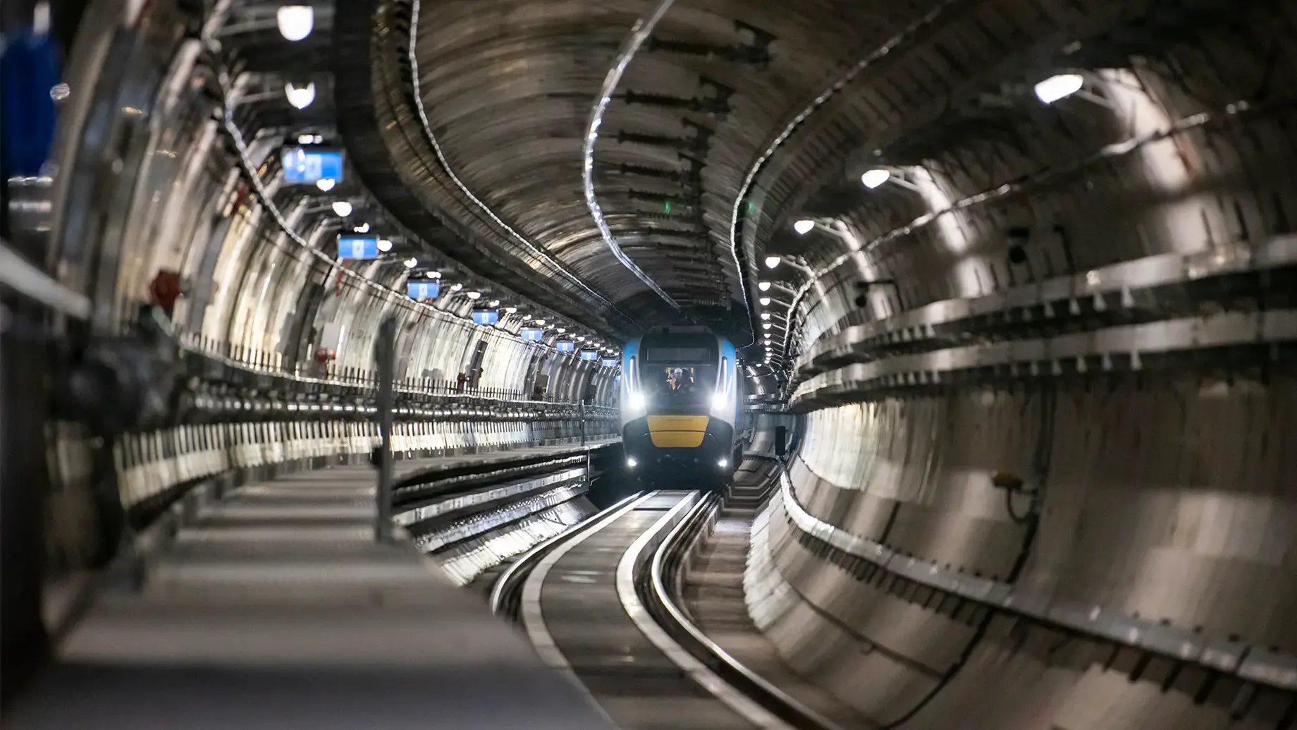A train moving along the tracks inside a metro tunnel