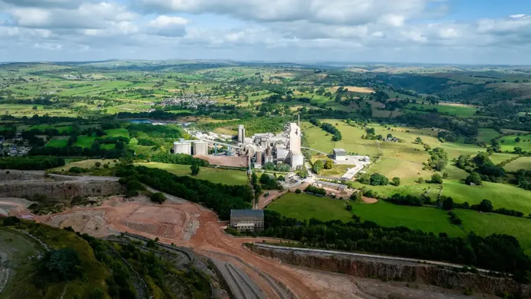 A large white building in a green landscape.