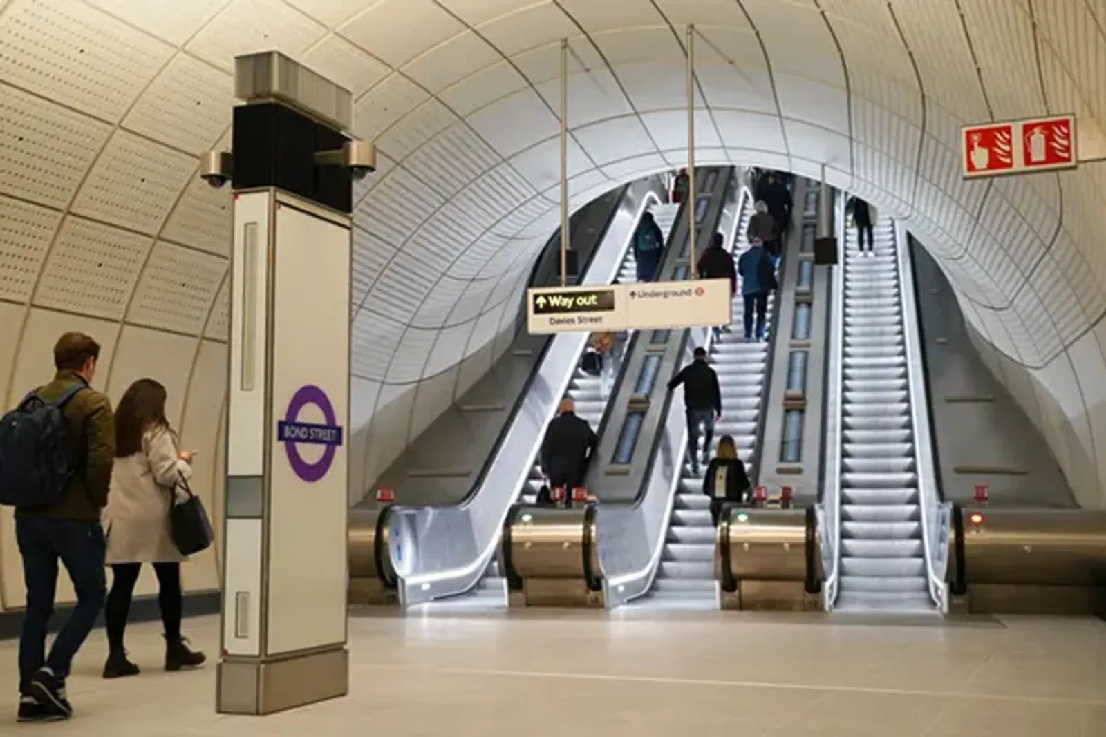 Passengers using an escalator in an Elizabeth Line station