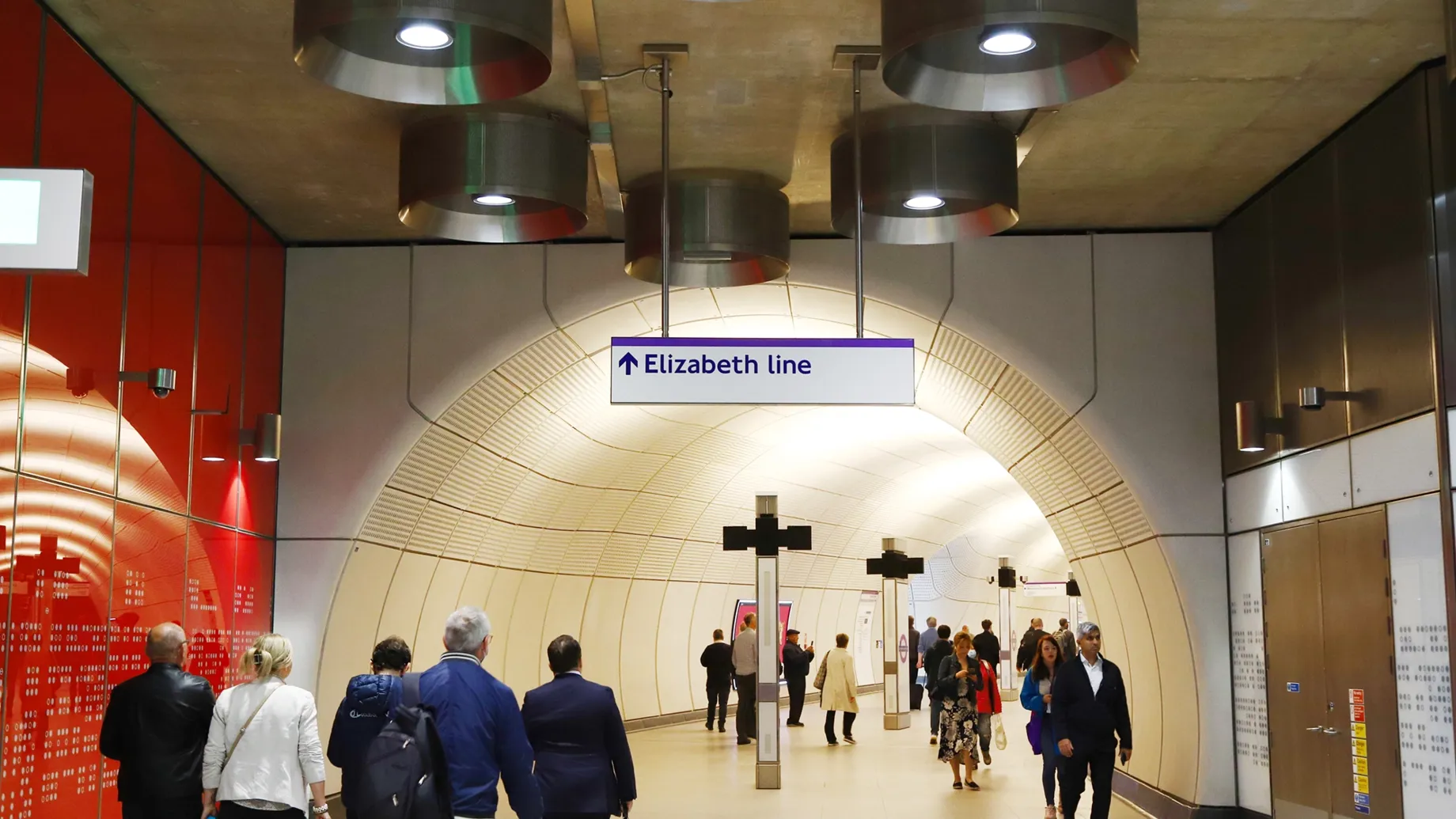 A group of people walking in a large building.