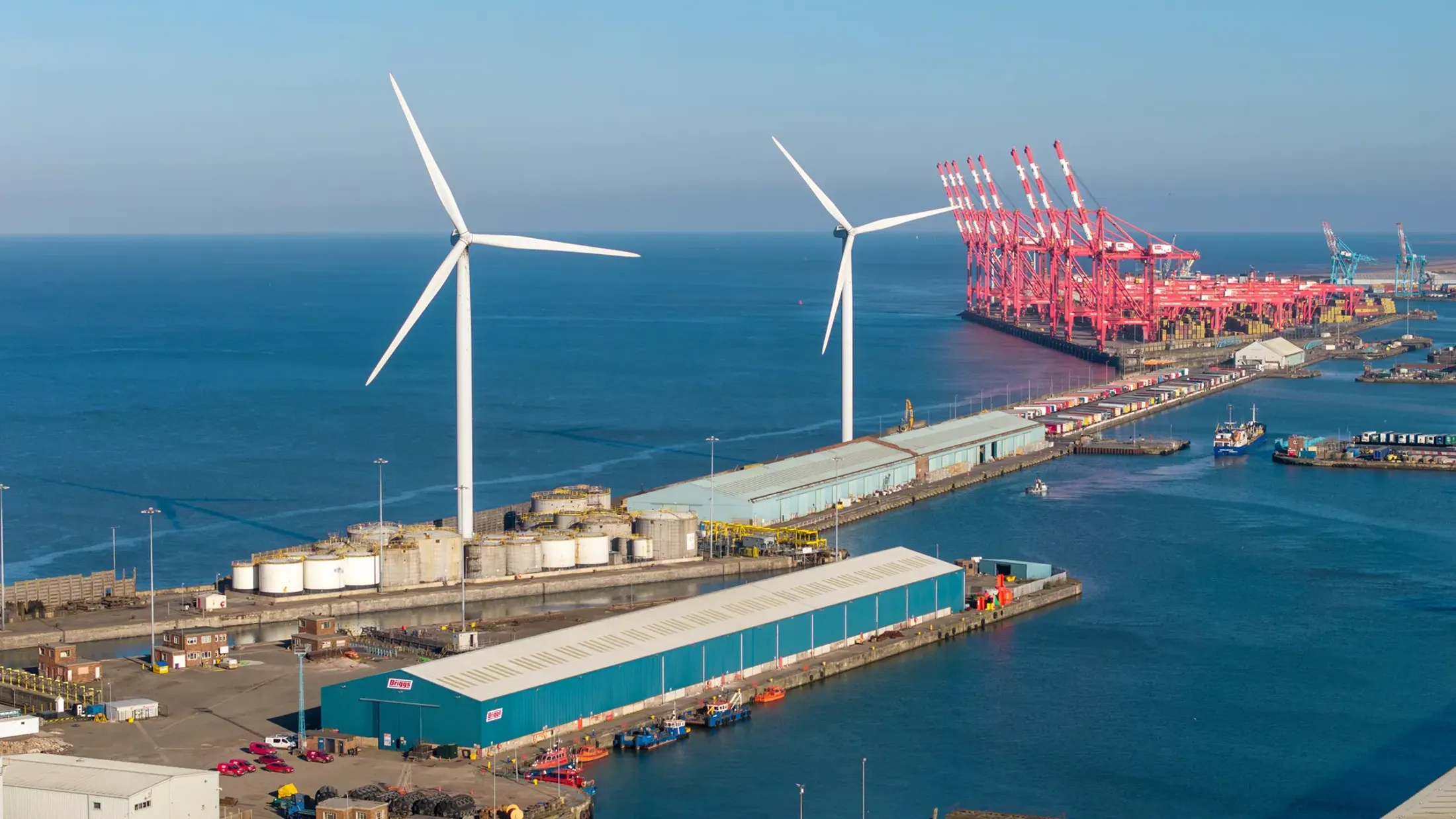 A group of wind turbines on a dock.